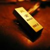 Crafting Captivating Headlines: Your awesome post title goes here A striking close-up of a gold bar showing inscriptions, captured with warm lighting.